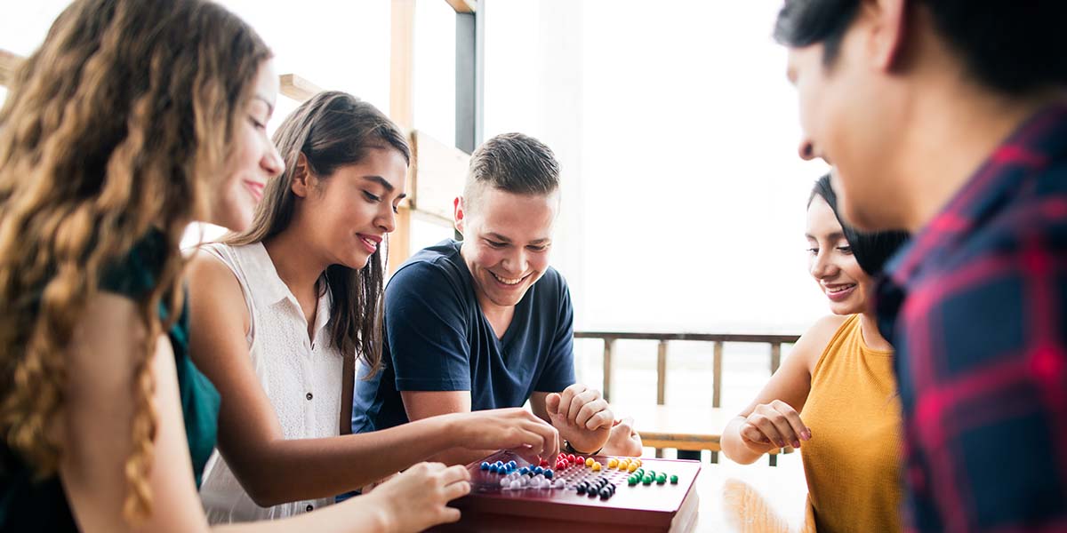 Young people enjoyig time with a boardgame