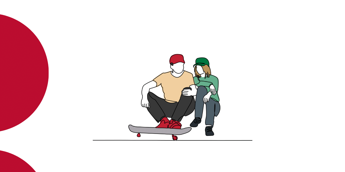 two people sitting and talking with a skateboard